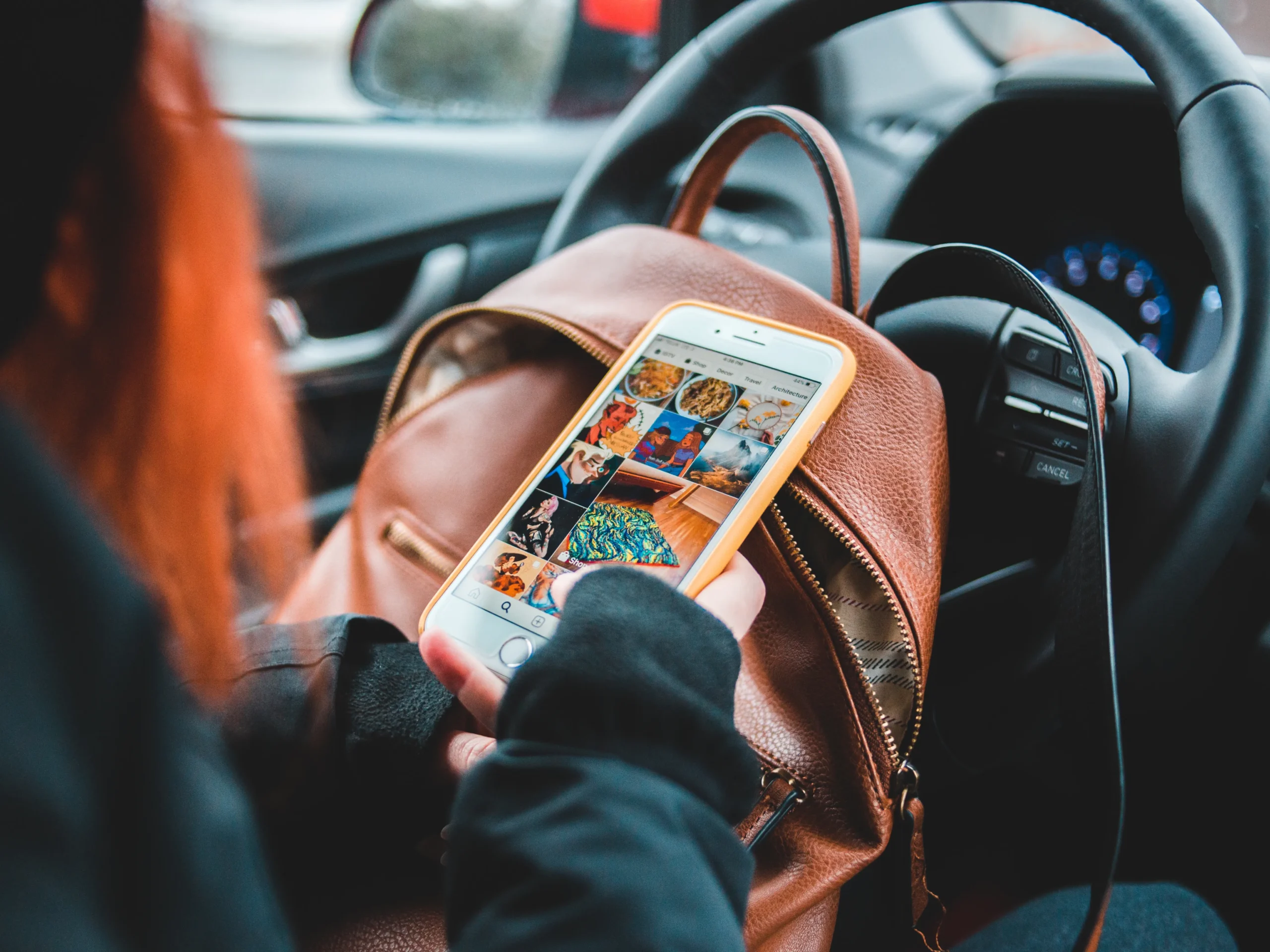 example of social media to show where to use a logo - person on phone in car
