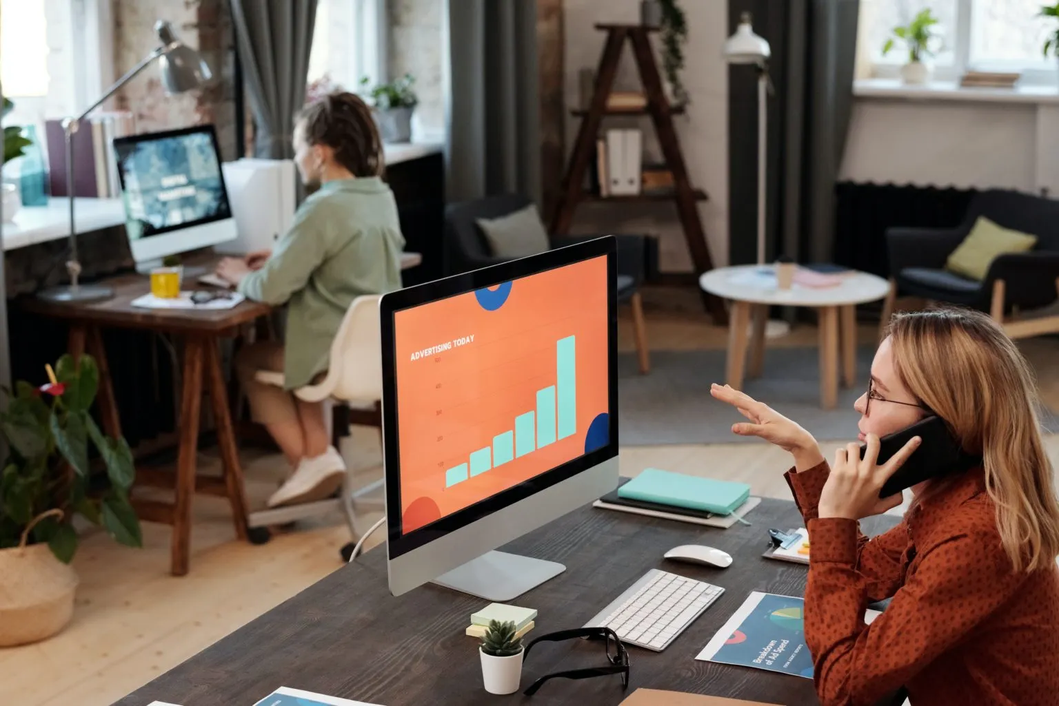 Why is Advertising Important? People in an office setting sitting at their desk working hard