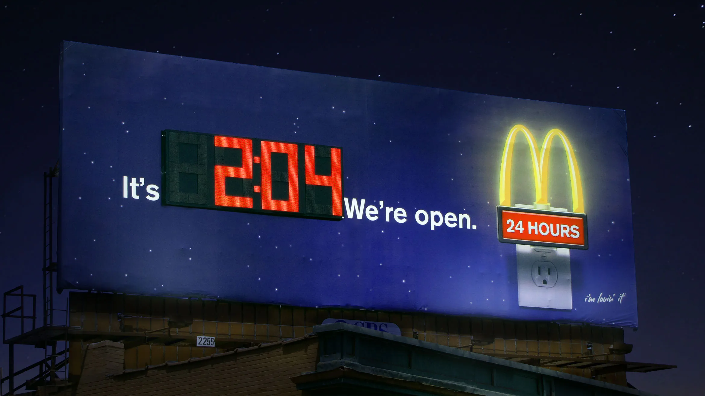 McDonald's digital billboard with a clock that changes to show they are open 24 hours