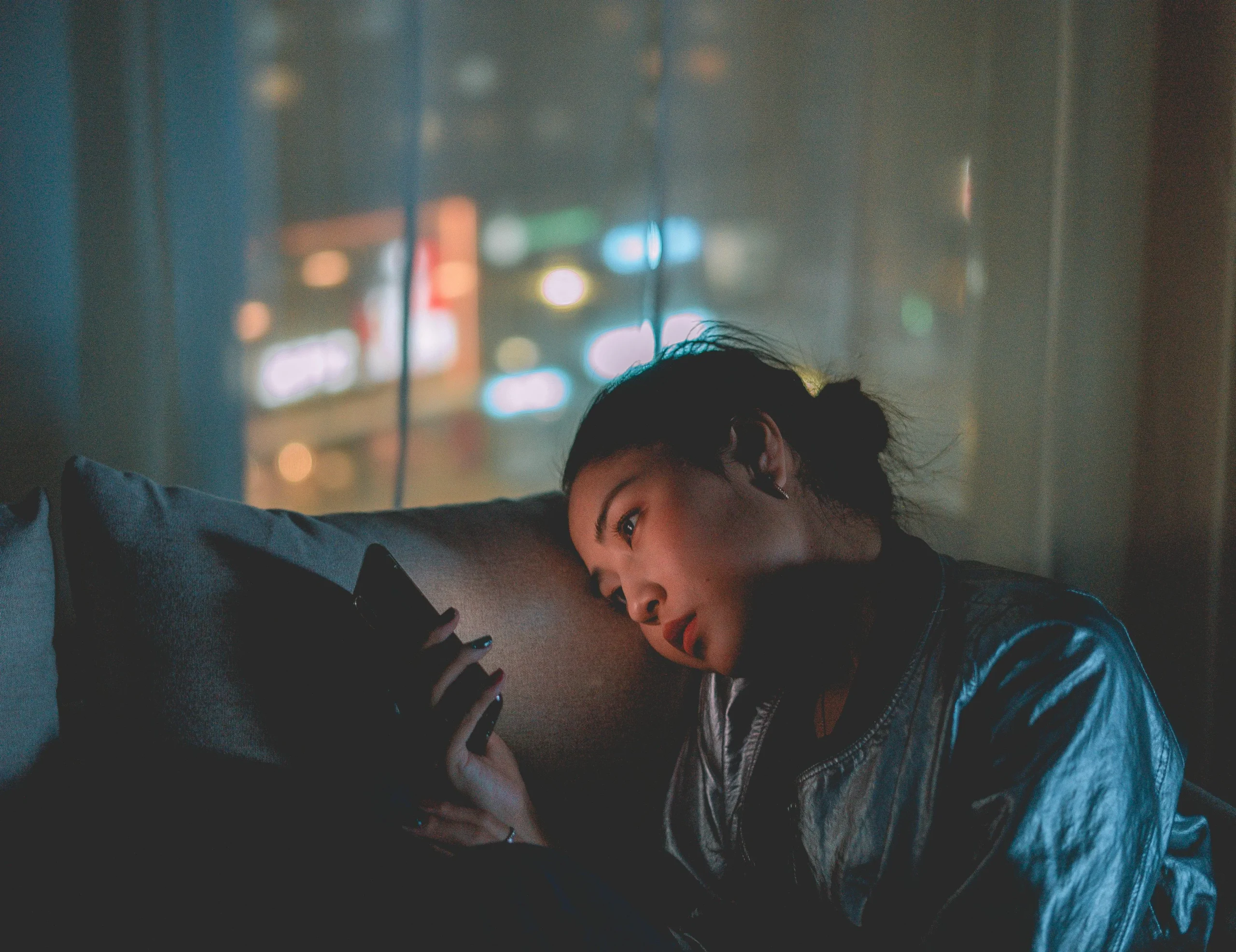 Woman looking at her phone on the couch