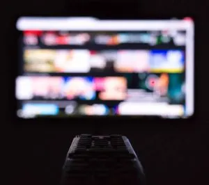 Remote control points at blurry tv screen