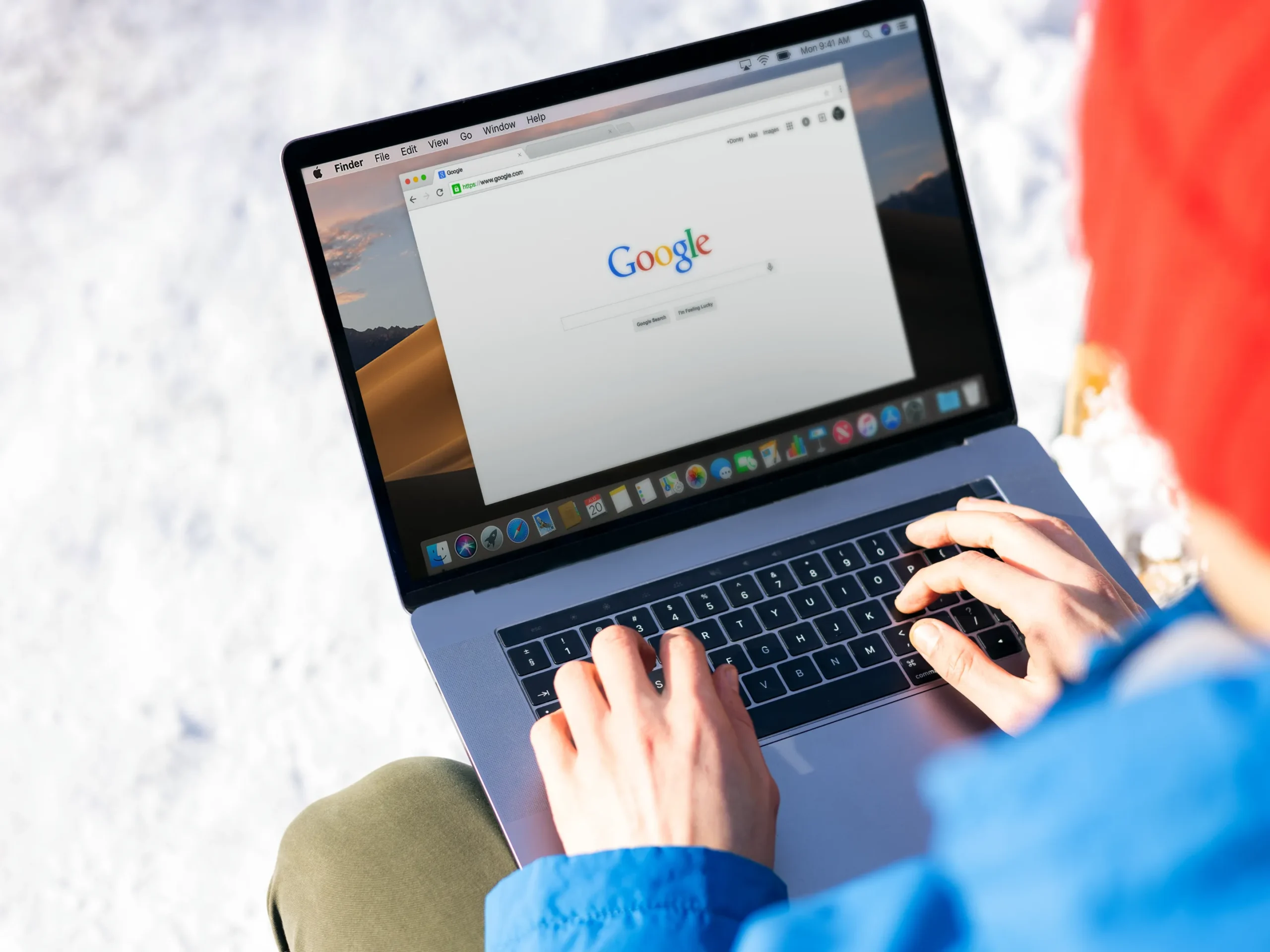 person on laptop outside using Google search engine